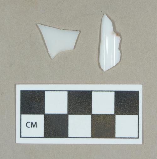 Glass, curved milk-glass body fragments