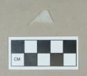 Glass, opaque colorless flat body fragment