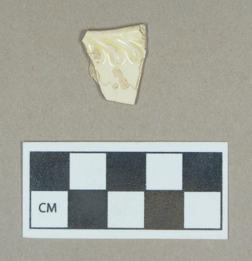 Ceramic, creamware rim sherd with feather edge molding