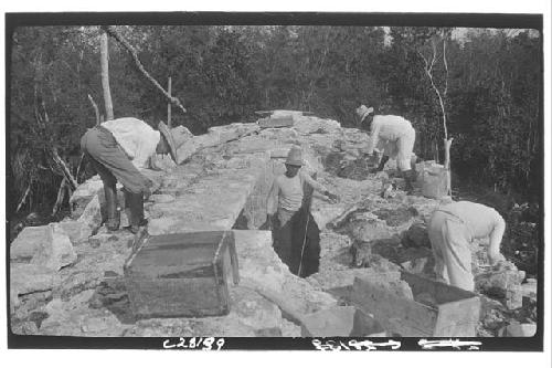 Temple of Three Lintels, laborers working on roof during restoration.