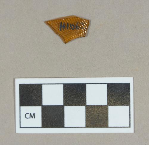 Glass, textured brown bottle body fragment