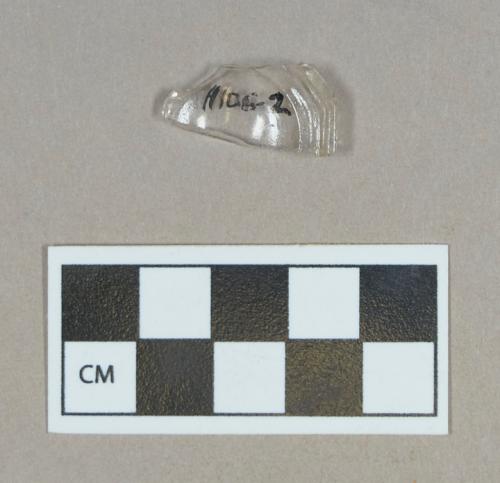 Glass, colorless bottle base fragment