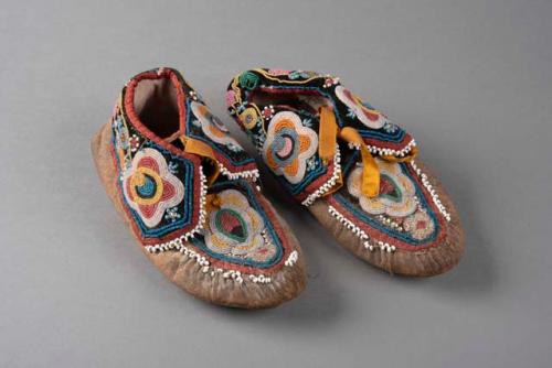 Pair of Passamaquoddy moccasins. Hide lined w/ cloth. Soft soles, cloth cuff.