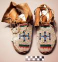 Pair of Northern Ute moccasins. Hard soles w/soft uppers.