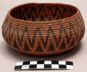 Bundle coiled basket, probably from Great Basin. Bowl shaped. Dark design elemen
