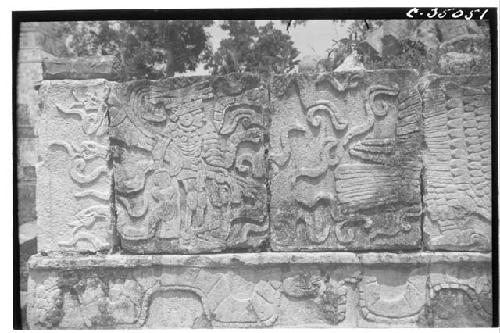 Serpents in bas relief. SE. corner Annex Tzompantli.