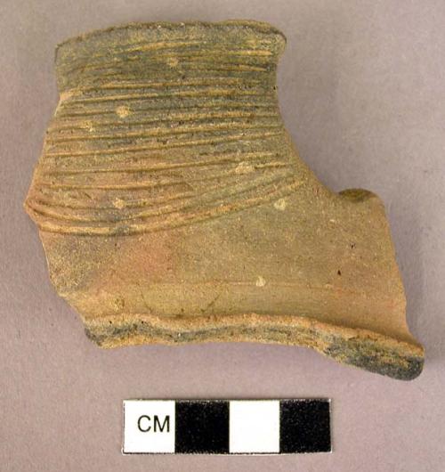 Brown-grey rim potsherd - horizontally incised lines