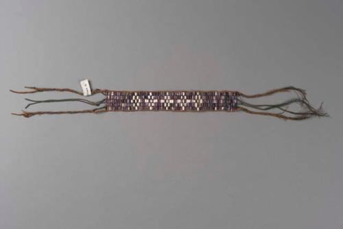 Wampum collar. Purple wampum background, white design.