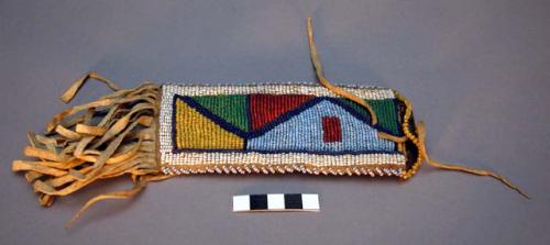 Pouch for ration ticket--fringe at bottom; triangular beaded pattern on front