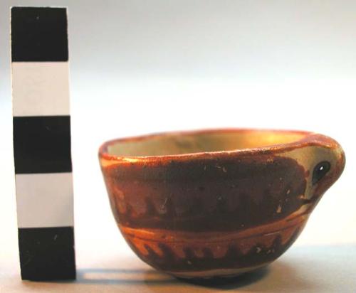 Miniature pottery vessel, red, orange and pink on buff