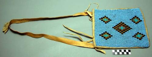 Leather bag with front of solid beadwork in blue, black, and yellow beads.