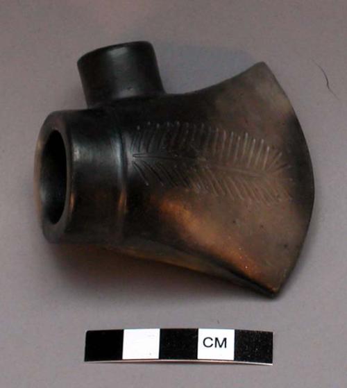 Ceramic pipe bowl. Flared "ax head" shape, with feather-like incising both side