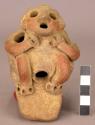 Rattle leg from large vessel.  Human figure with hands on neck.  Red ware