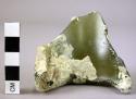 Green glass bottle sherd, side and one edge of bottom. 7 cm dia x 6.3 cm h. x .8