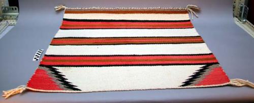 Banded saddle blanket. Grey, pink, black, brown and white stripes.