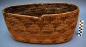 Oblong utility basket, coiled. Made of bear grass (natural and dyed).