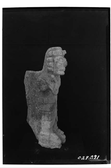 Human figure from front facade of NE Col. with headdress, side