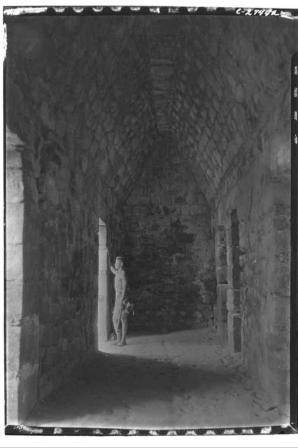 Boy in the doorway of an interior chamber at Monjas