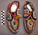 Pair of Passamaquoddy moccasins. Hide lined w/ cloth. Soft soles, cloth cuff.