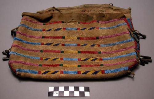 Rectangular pouch of tan buffalo decorated with bands of beading