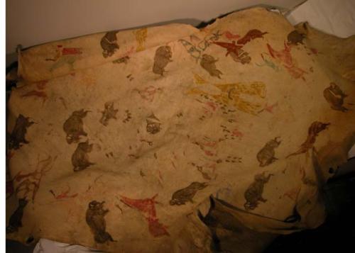 Painted bison hide. Painted designs in red, blue, brown and green