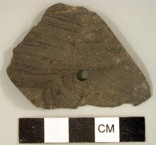 Ground stone, worked stone fragment, one perforation, possible gorget fragment