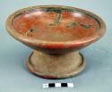 Redware vessel, annular base.  Incised curvilinear designs on interior.