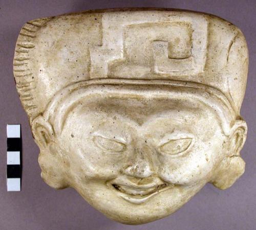 Cast of "laughing face" - geometric design in bas relief on forehead