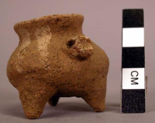 Miniature tripod jar - white on buff ware, lug on side in form of face