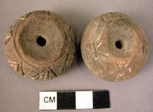 2 pottery spindle whorls with incised and colored disigns