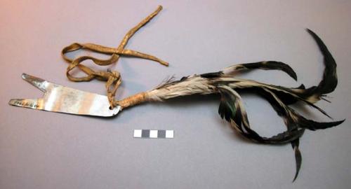 Ceremonial hair ornament? pronged piece of tin attached by skin thong to 6 long