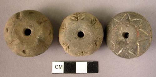 Pottery spindle whorl with incised designs