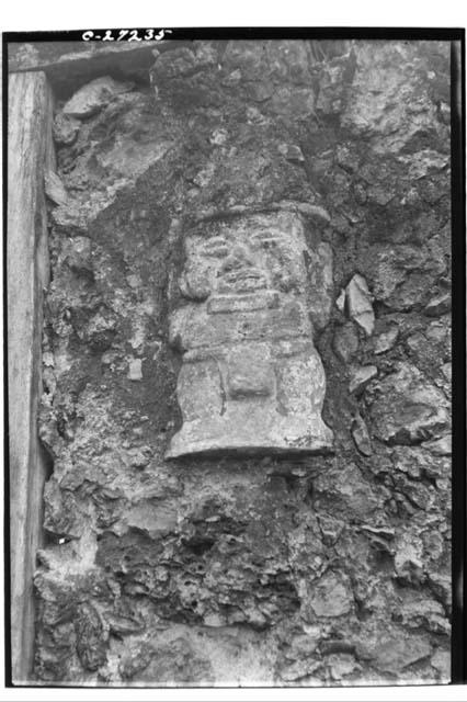 Stone statuette imbedded in wall in the village of Tixmucuy (Facing Novia)