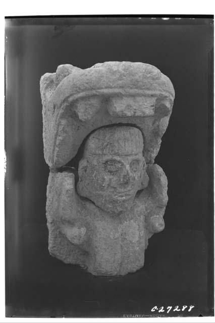 Human head in mouth of serpent, from panel front of NW Col