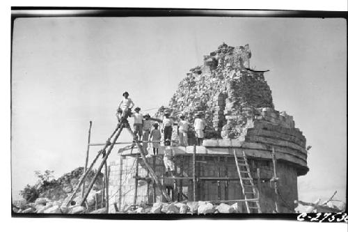 Caracol. Raising stone block for restoration in 5-member cornice. More distant v