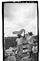 Caracol. Laborer carrying stone nose for mask over S. doorway