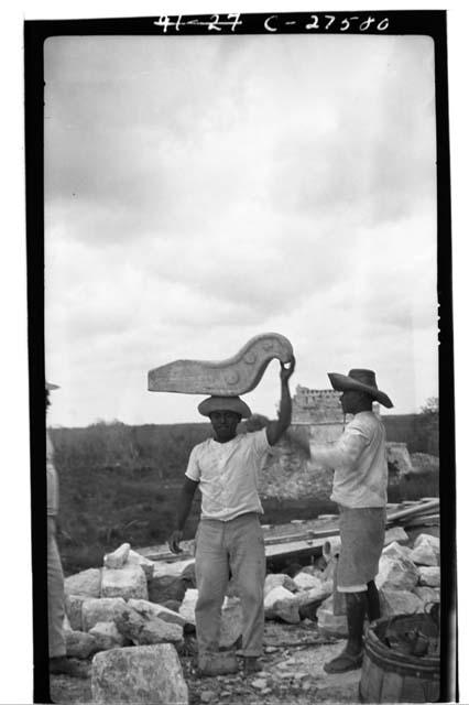 Caracol. Laborer carrying stone nose for mask over S. doorway