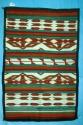 Early Chinle rug, orange and red geometric form on white