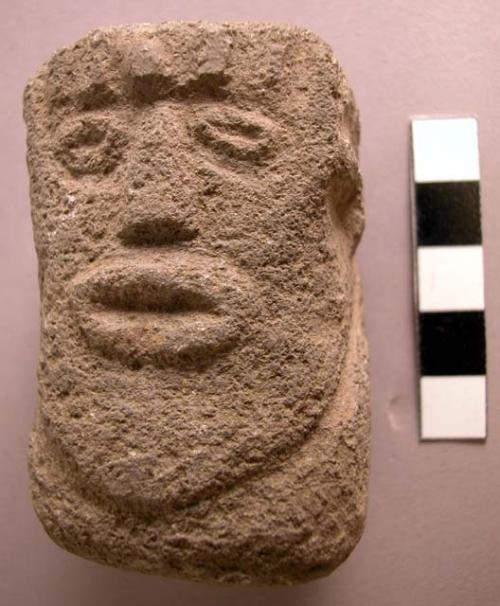 Carved stone human head