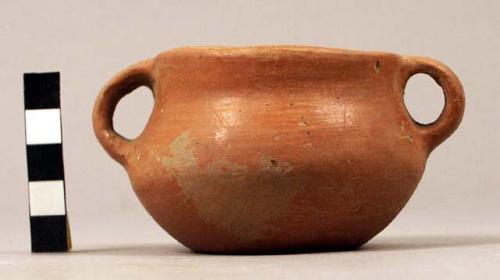 Small red plain ware bowl, dimpled base & 2 handles