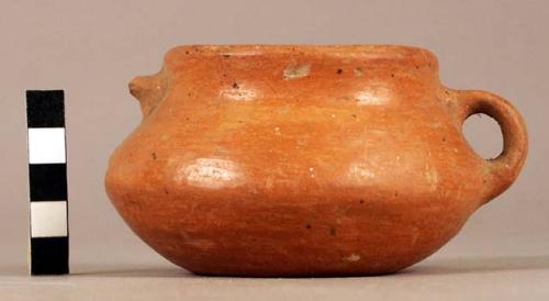 Small plain red pottery bowl, dimpled base & 2 handles ( 1 broken)