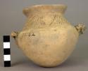 Pottery jar, monkey on side, incised about neck