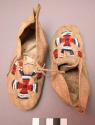 Pair of child's moccasins - red, white and blue bead decoration