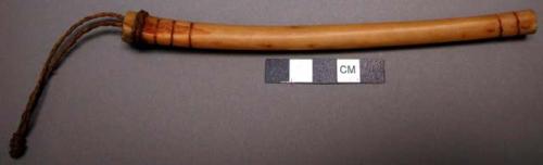 Pubescent's bone whistle with three holes. Ornamented with incised rings.