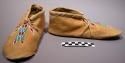 Tanned deerhide moccasins with rawhide soles. decorated with turquoise, red and