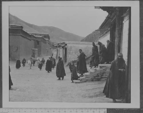 Copy negative of lamas exiting temple at Labrang