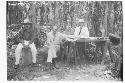 Staff members sitting by mound