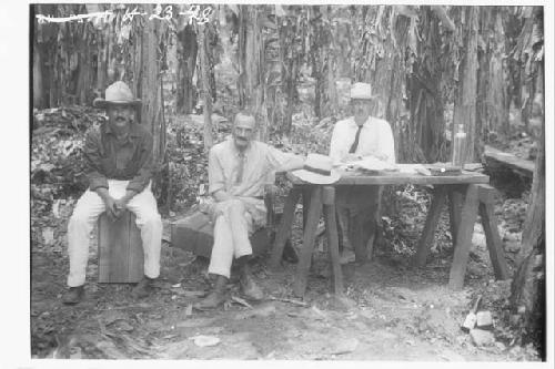 Staff members sitting by mound