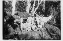 Laborers standing in front of camp