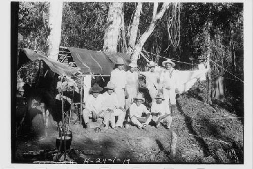 Laborers standing in front of camp